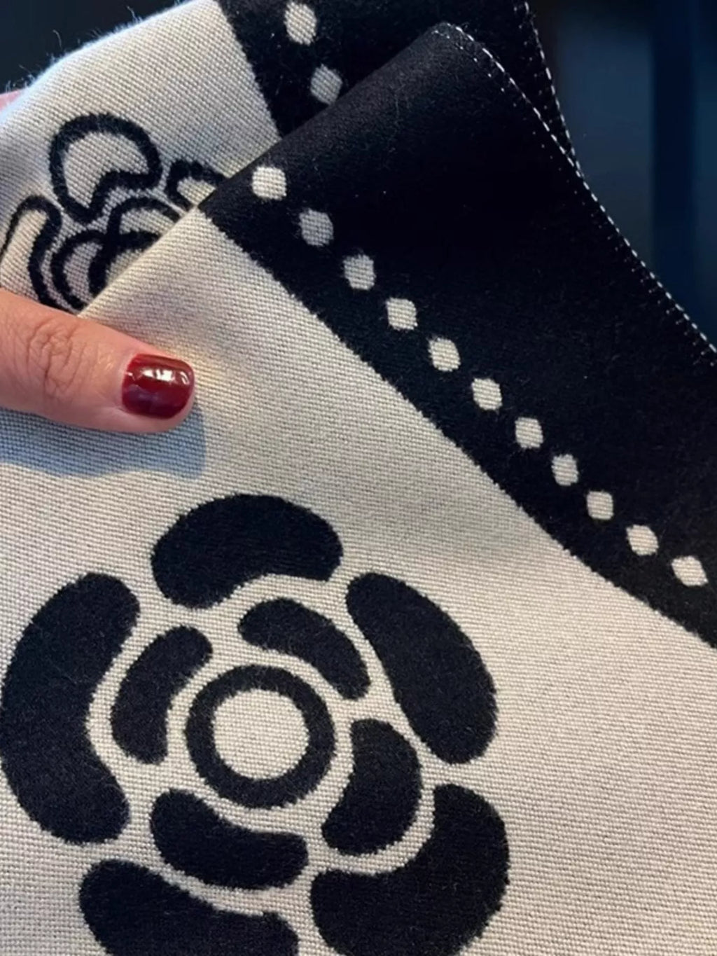 Close-up of a black and white patterned fabric with a rose design.