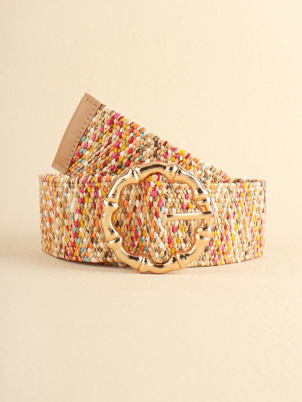 Multicolored woven belt with a gold buckle on a beige background