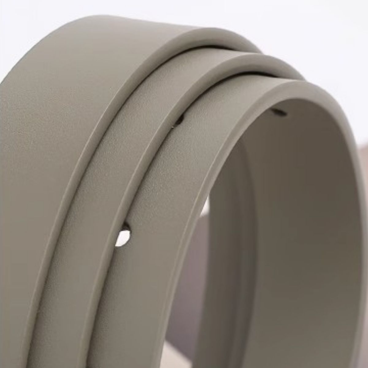 Close-up of a beige rubber strip on a light gray background