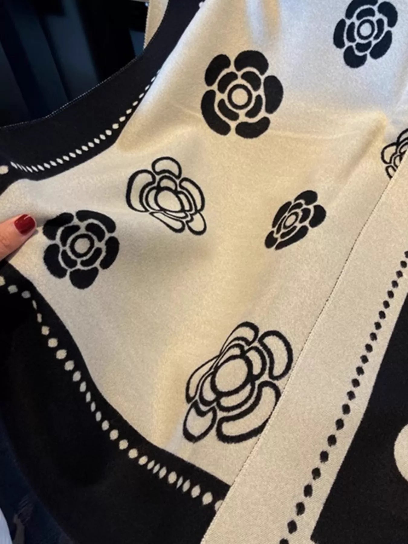 Close-up of a black and white patterned fabric with floral designs.