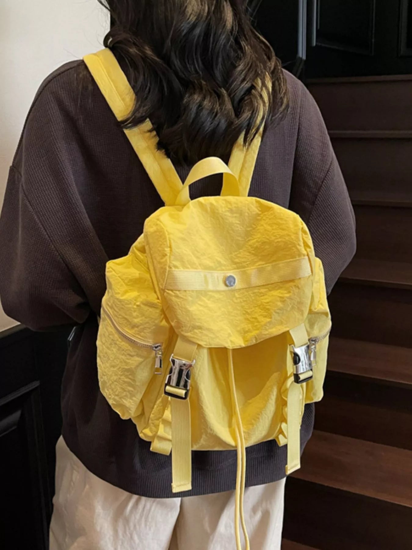 Person wearing a yellow backpack indoors