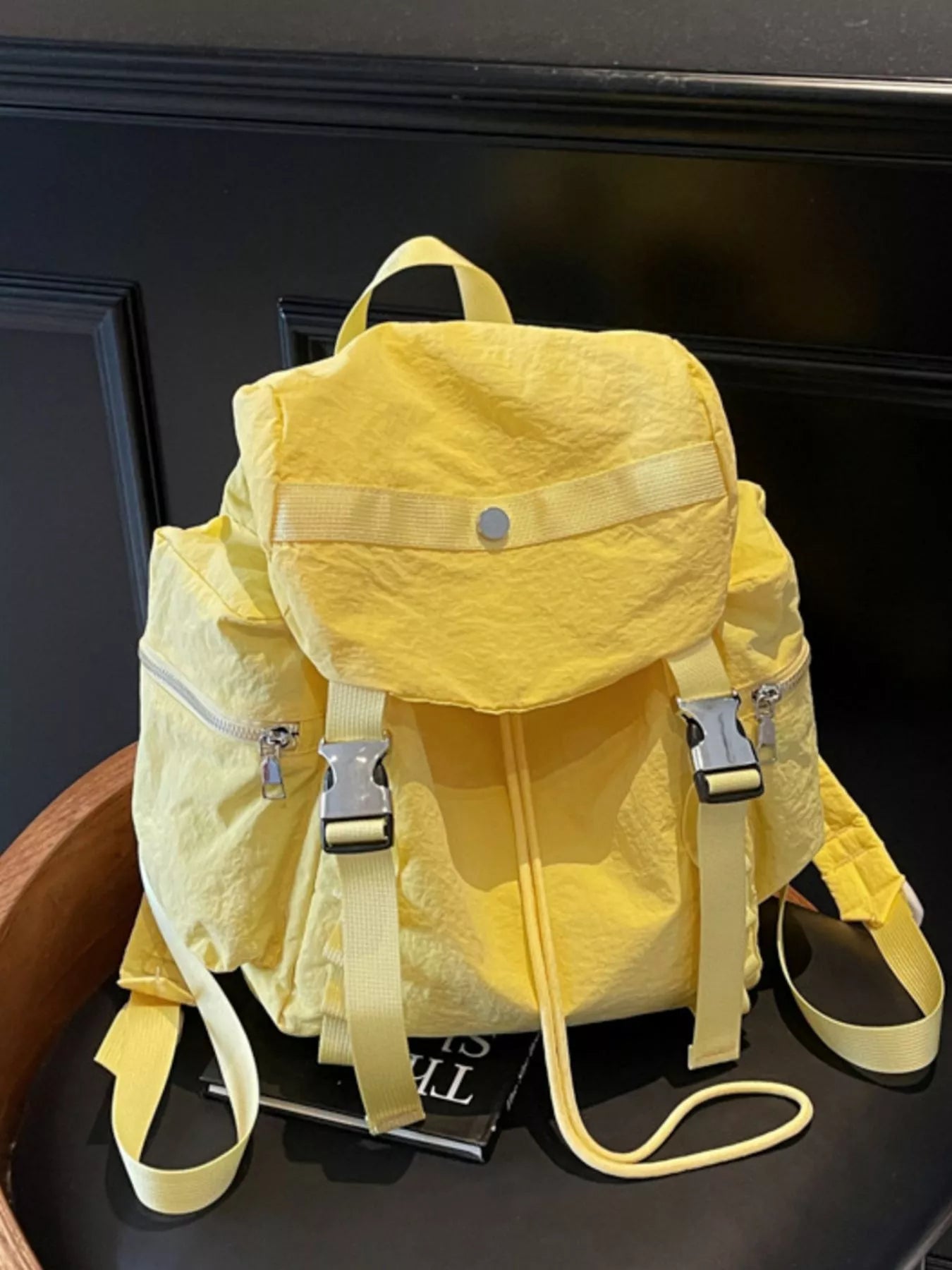 Yellow backpack on a dark surface