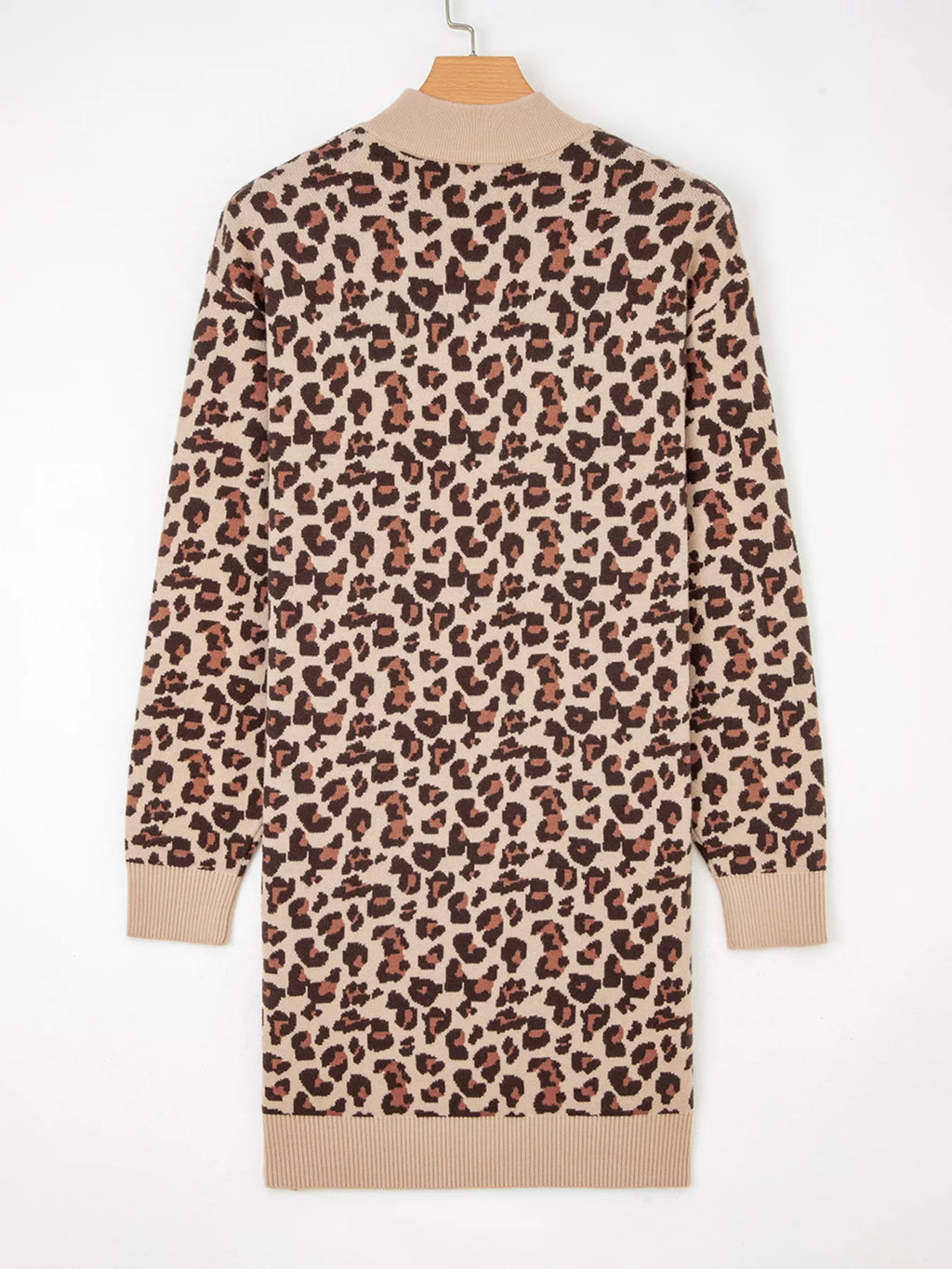 Leopard print dress on a hanger against a white background