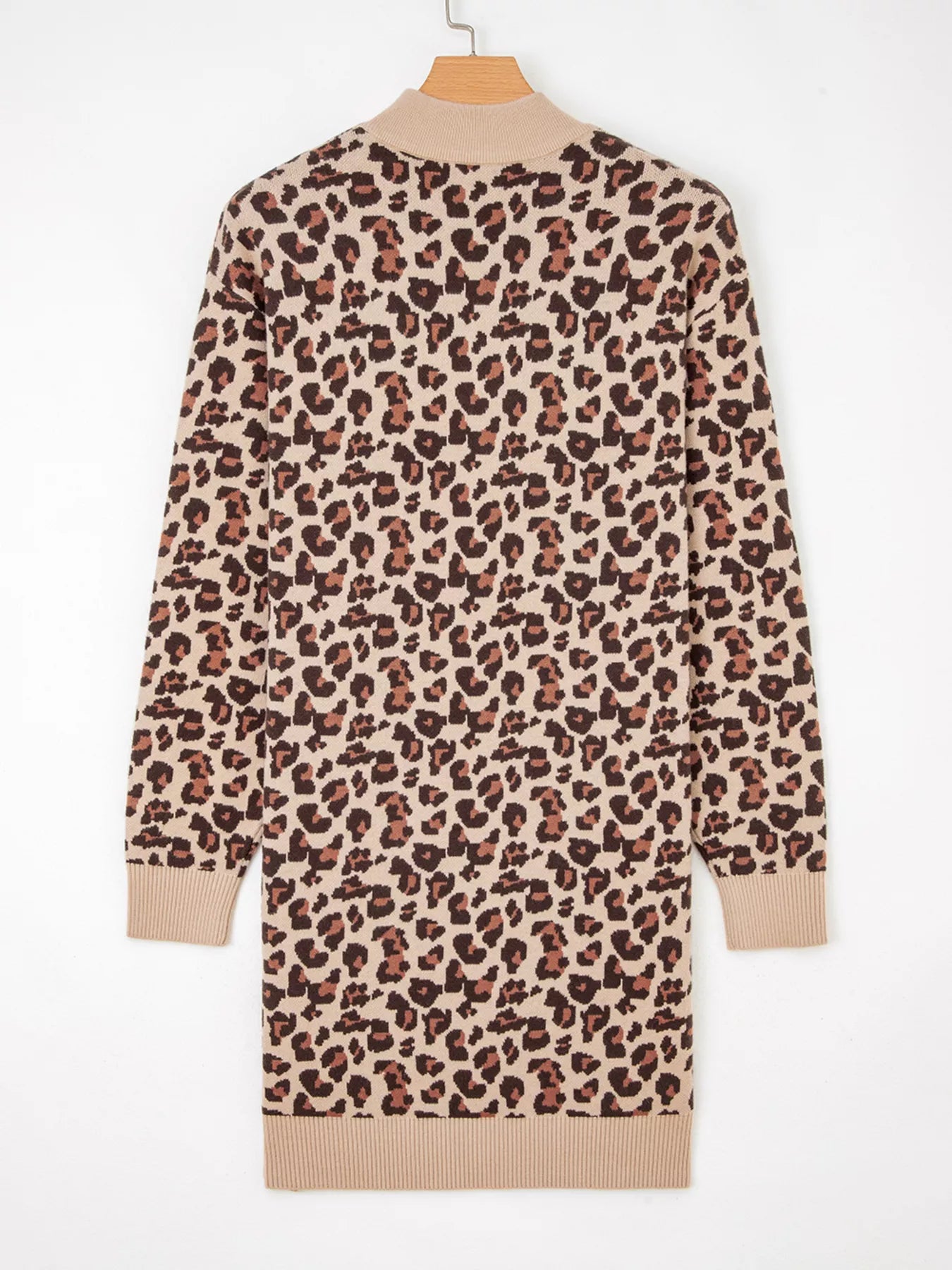Leopard print dress on a hanger against a white background