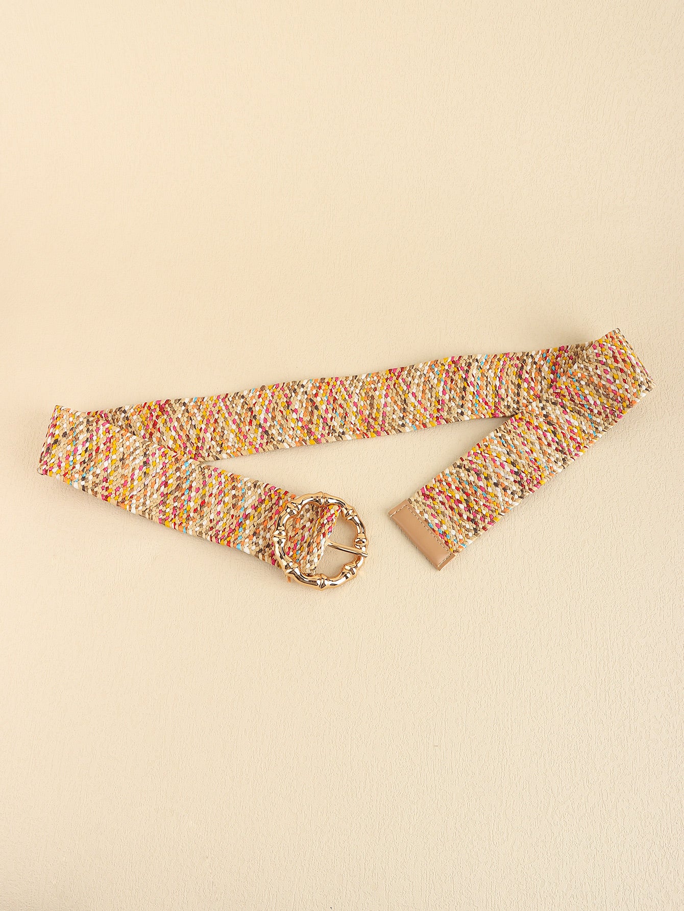 Multicolored belt with a gold buckle on a beige background