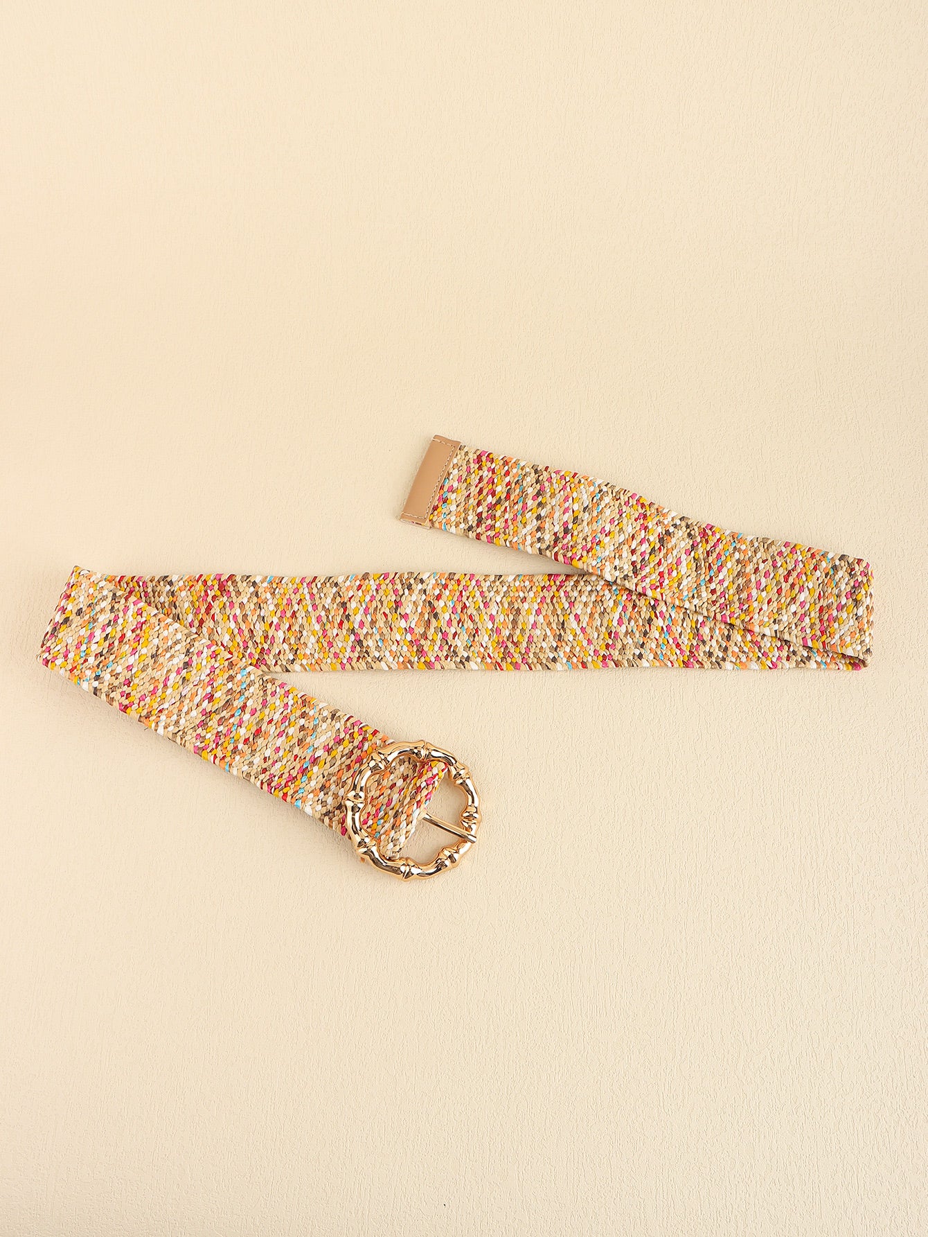 Multicolored belt with a gold buckle on a beige background