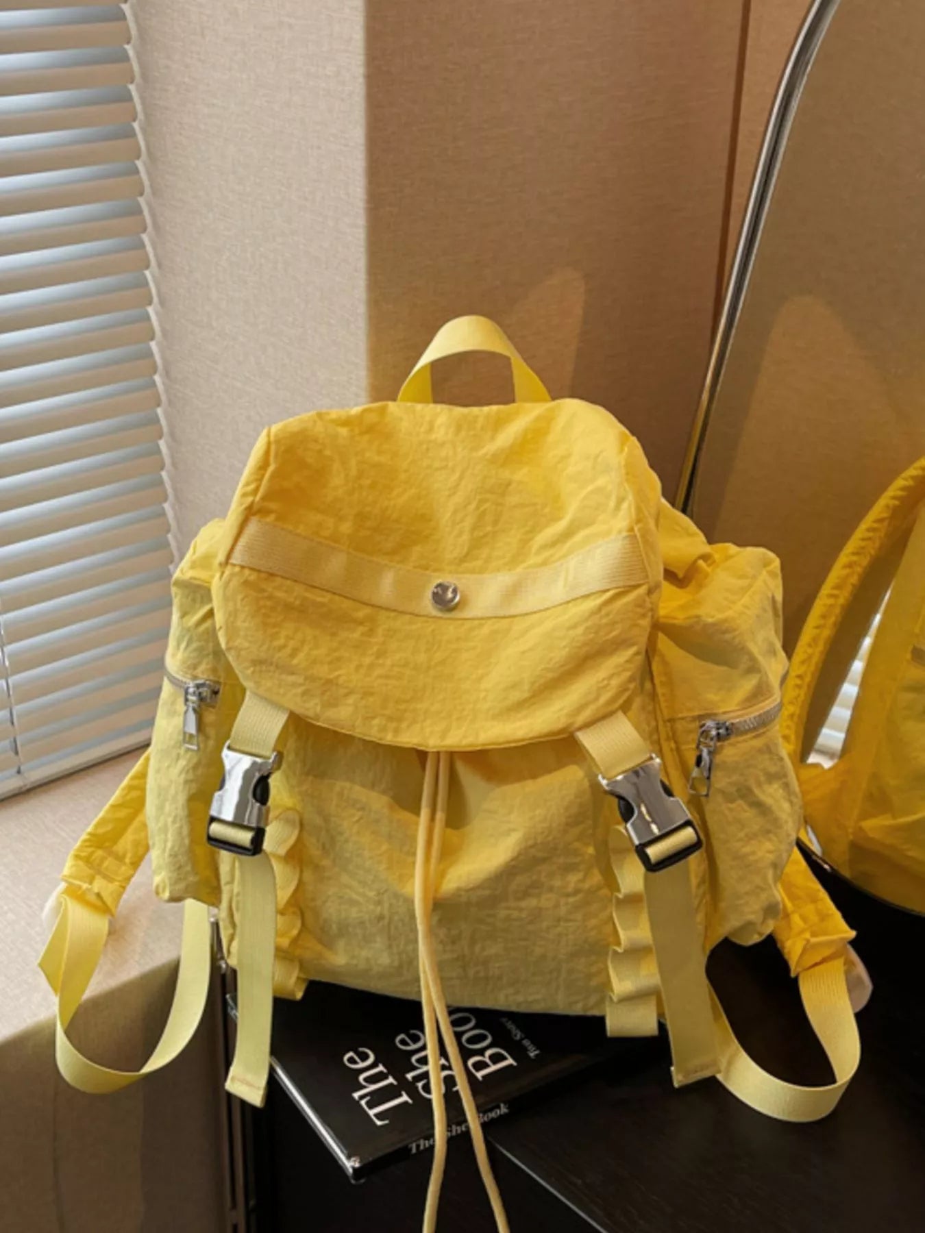Yellow backpack on a surface with a blurred background