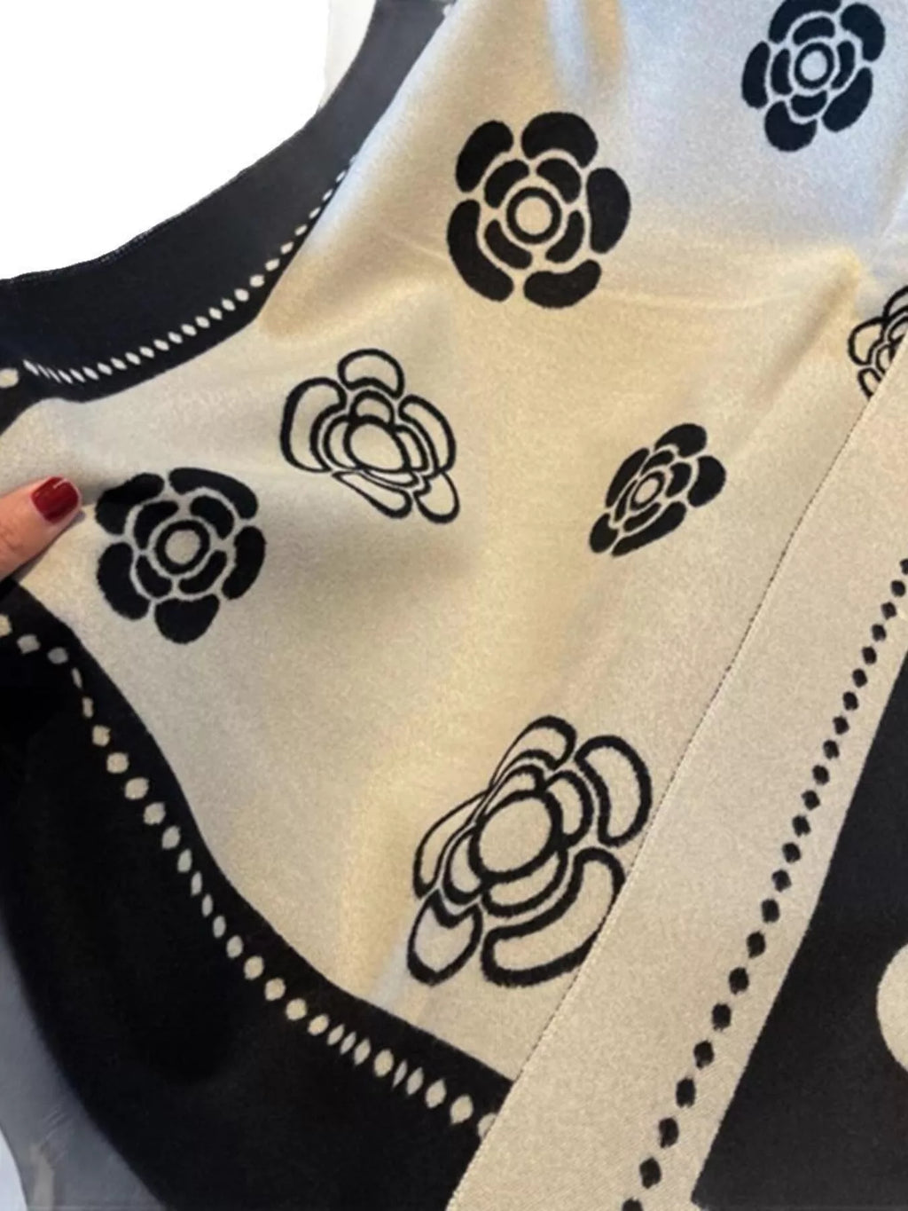 Close-up of a black and white patterned fabric with floral designs.