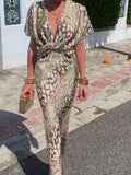 Person wearing a patterned outfit walking on a street.