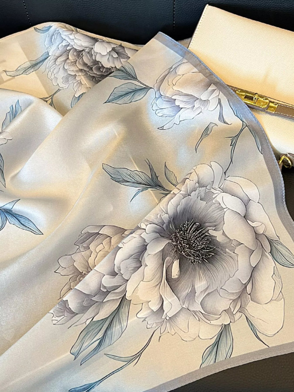 Floral patterned fabric with a neutral color palette on a plain background