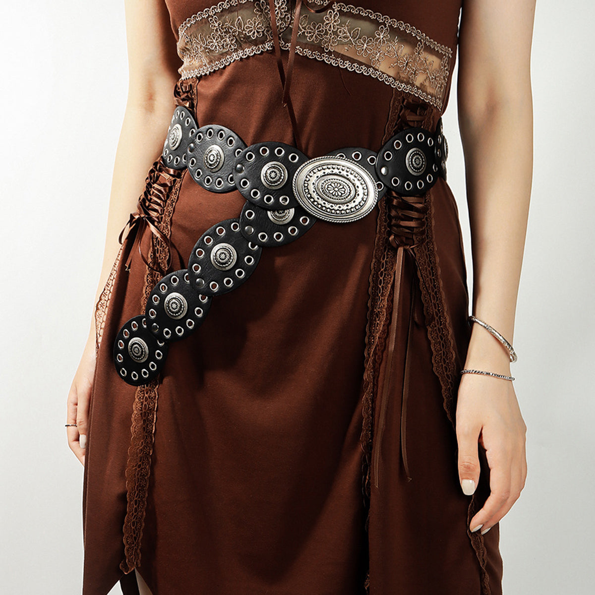 Brown dress with decorative belt on a plain background