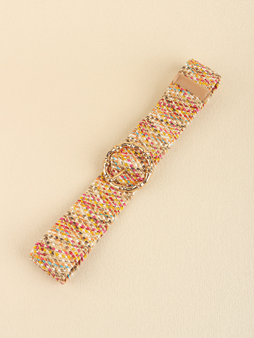 Multicolored woven belt with a circular buckle on a beige background