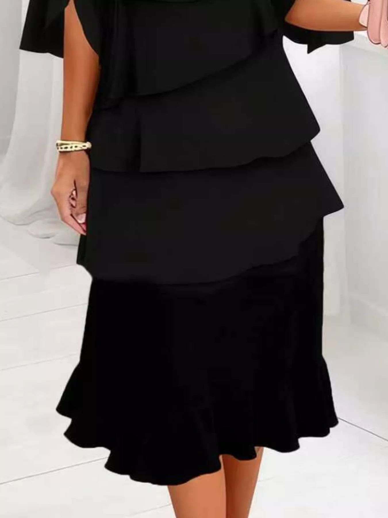 Black layered dress on a white background