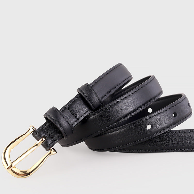 Black leather belt with a gold buckle on a light gray background