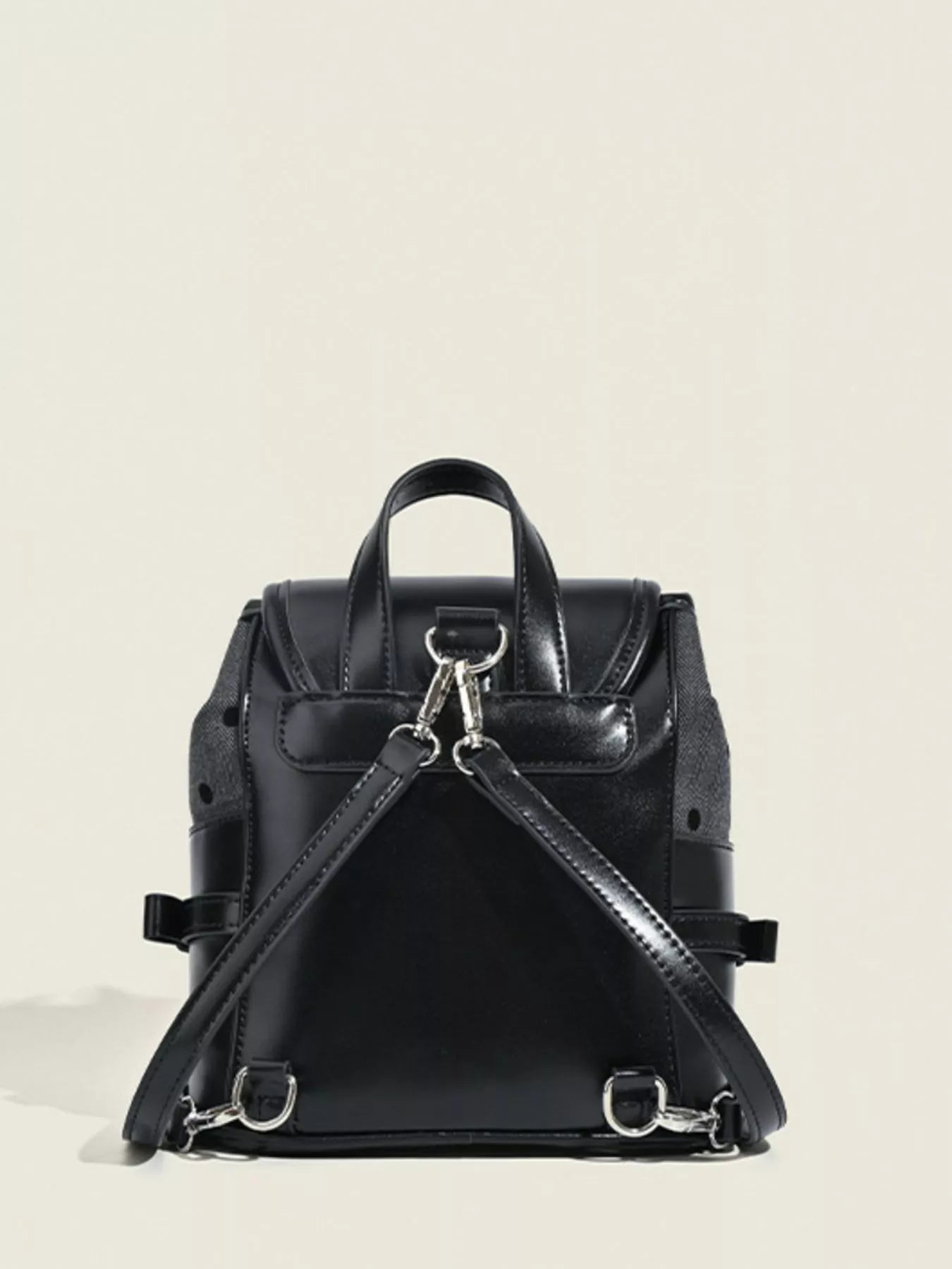 Black backpack on a light beige background