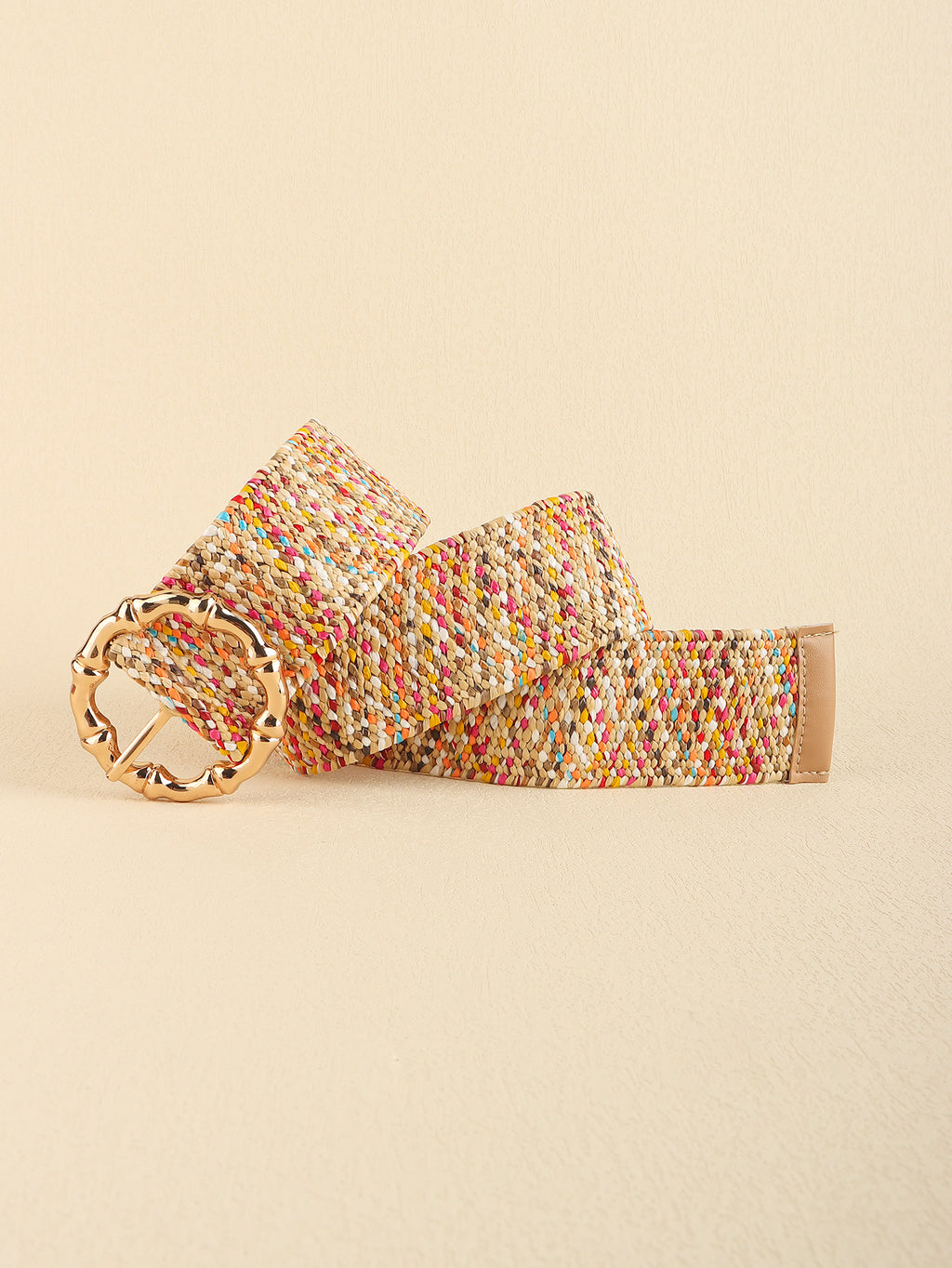 Colorful woven belt with a gold buckle on a beige background