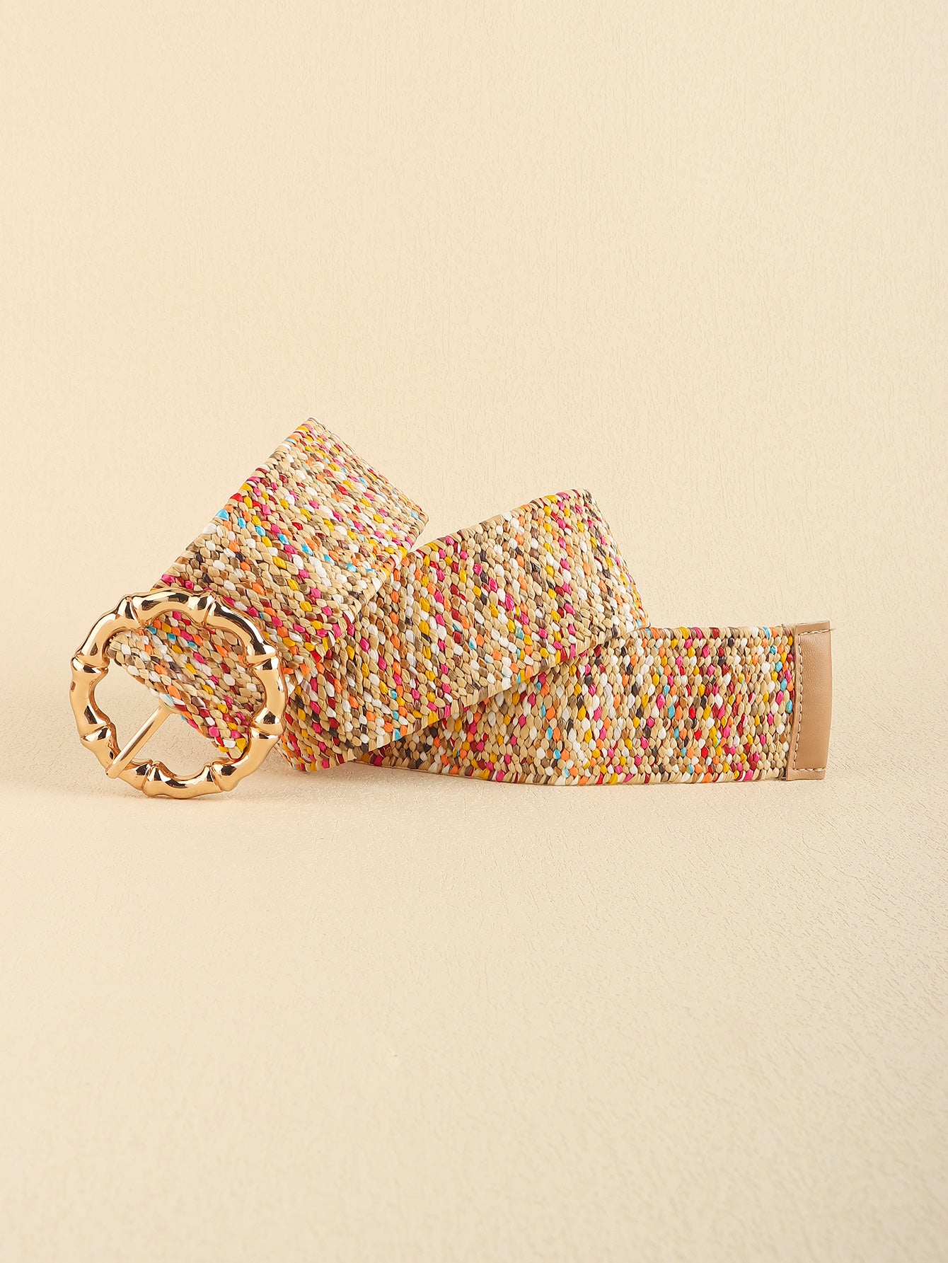 Colorful woven belt with a gold buckle on a beige background