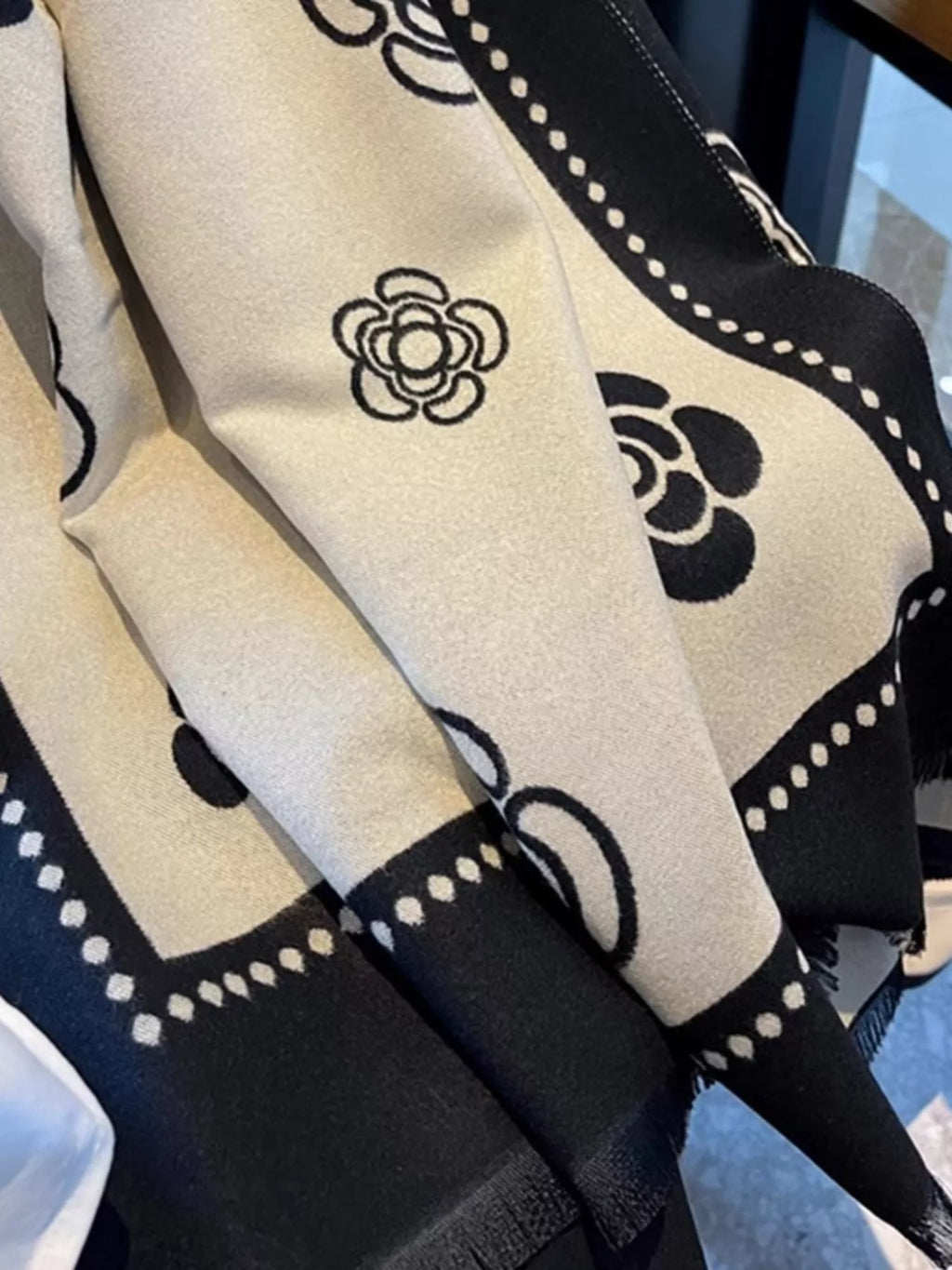 Black and white patterned fabric with a central design on a blurred background