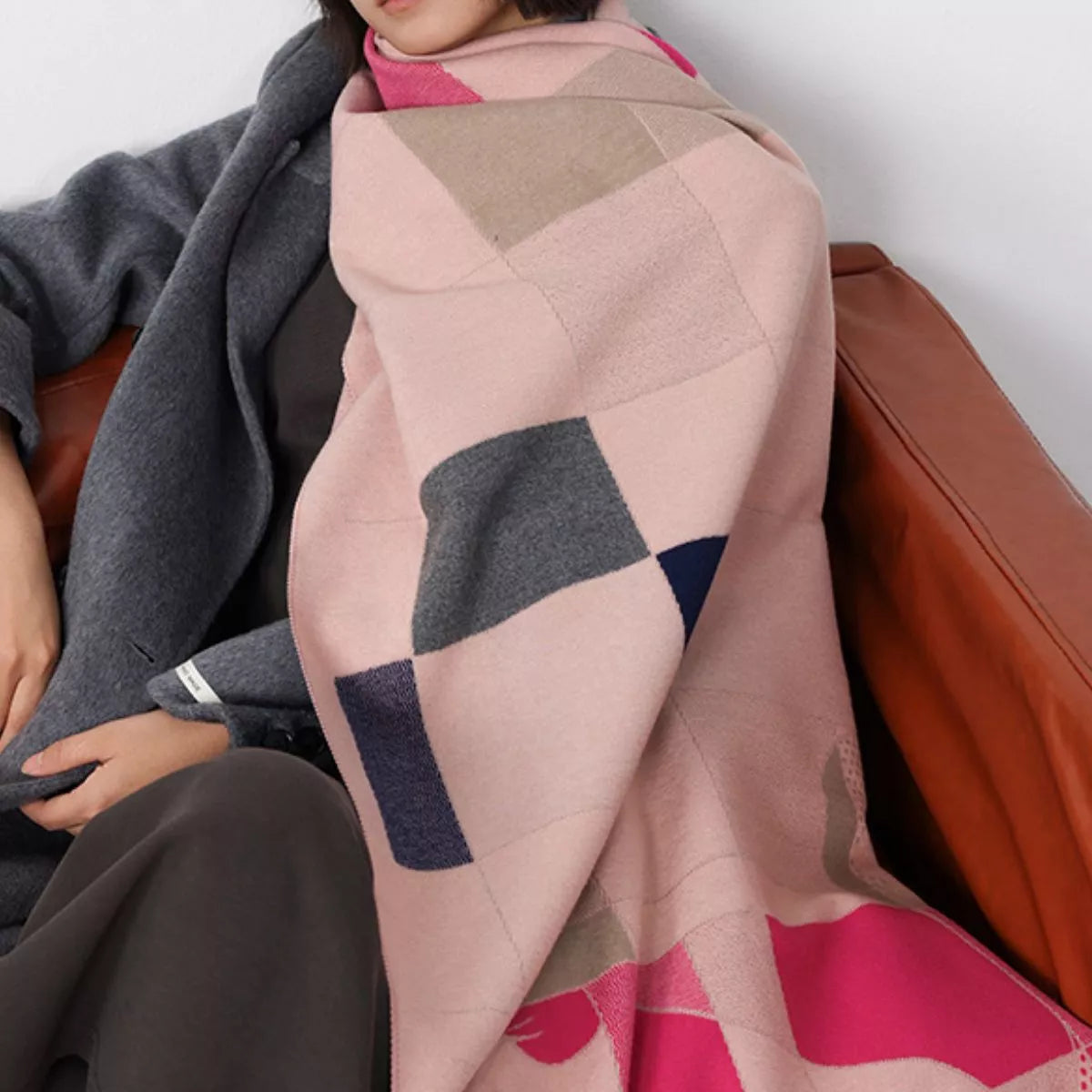 Model wearing a colorful geometric-patterned scarf with a neutral background