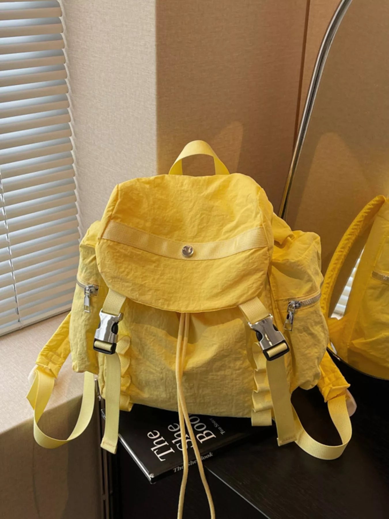 Yellow backpack on a surface with a blurred background