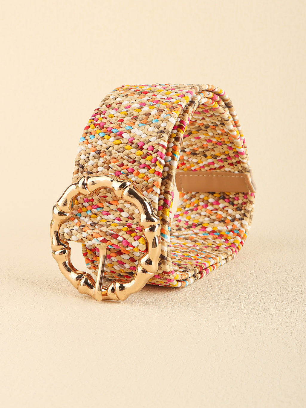 Multicolored woven belt with a gold buckle on a beige background