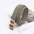 Gray belt with a gold heart-shaped buckle on a white background