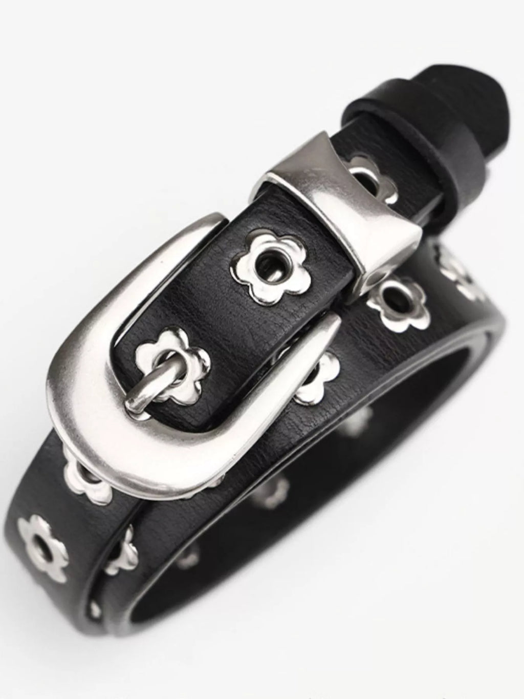 Black leather bracelet with silver buckle on a white background