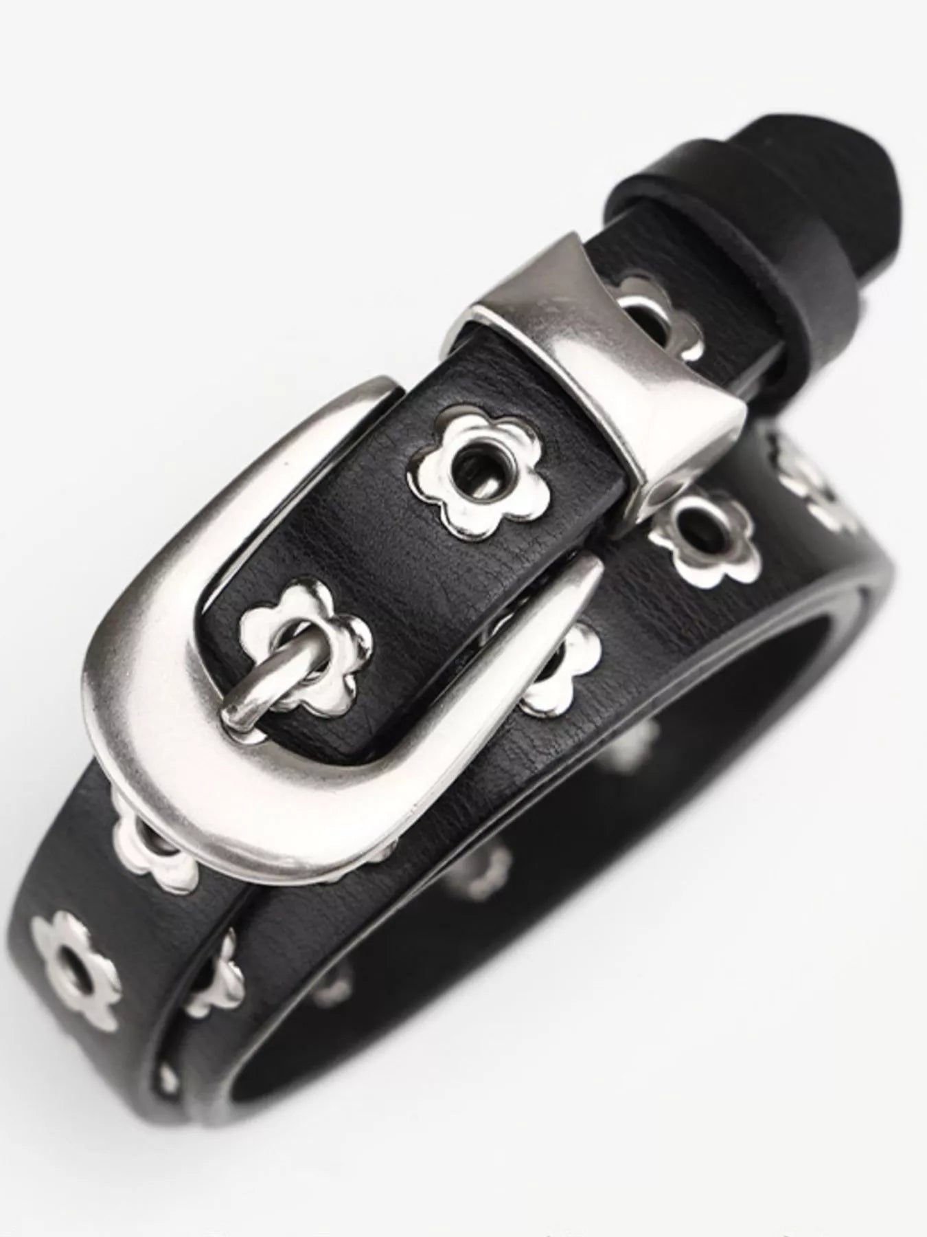 Black leather bracelet with silver buckle on a white background