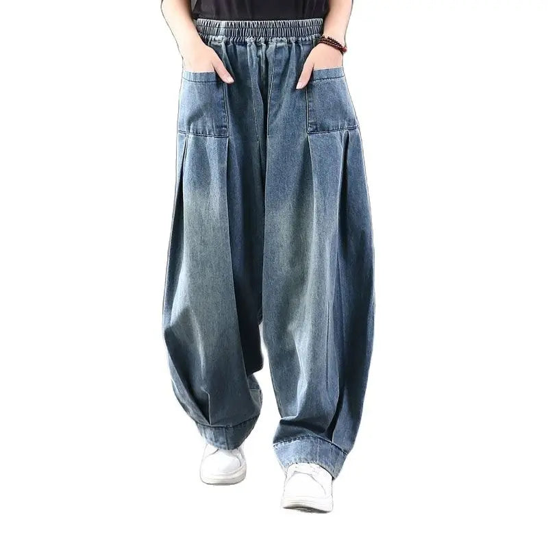 Blue denim baggy pants worn by a model on a white background