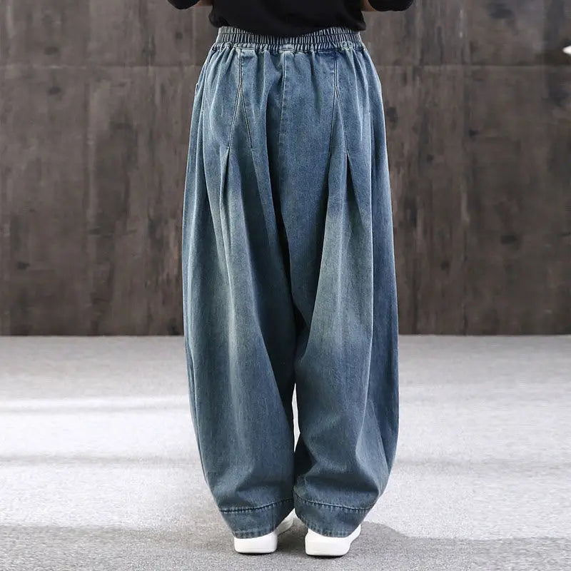 Blue denim wide-leg pants worn by a model against a neutral background