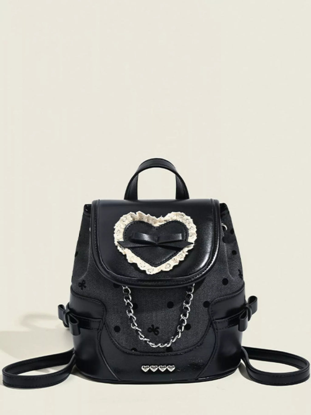 Black backpack with a heart-shaped design on a beige background