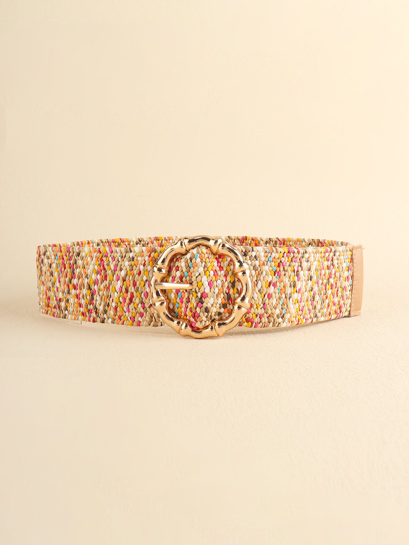 Multicolored beaded belt with a gold buckle on a beige background
