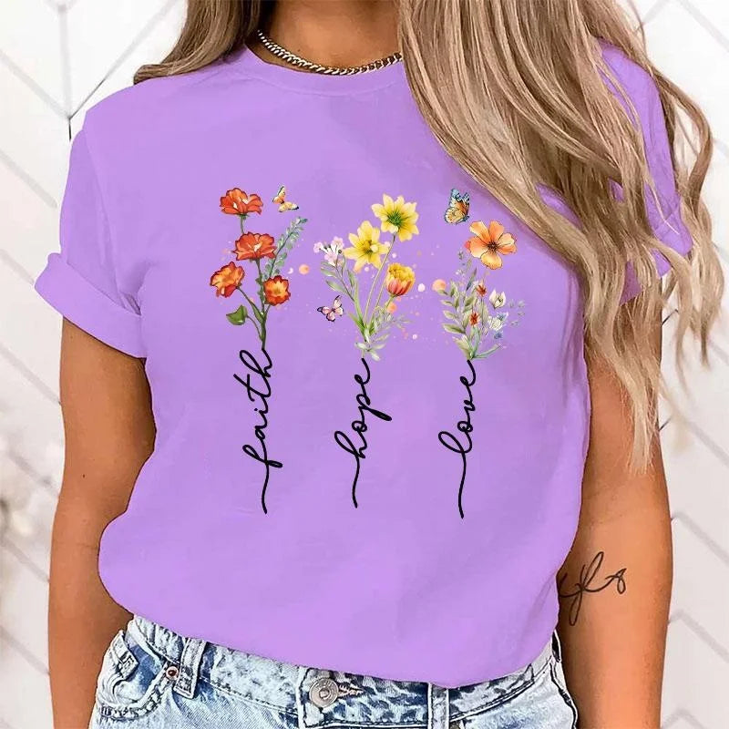 Purple t-shirt with floral designs and text worn by a person
