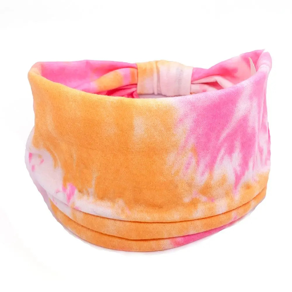 Tie-dye headband with pink and orange patterns on a white background