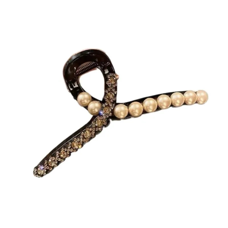 Hair clip with pearls and gemstones on a white background