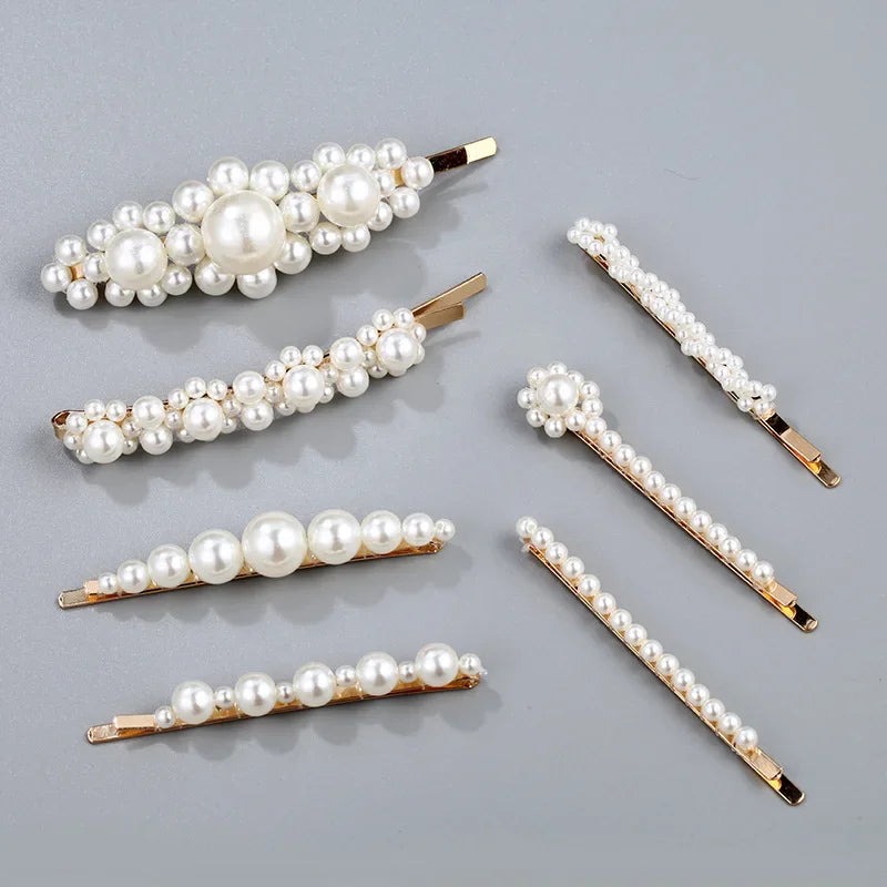 Set of pearl hair pins on a gray background