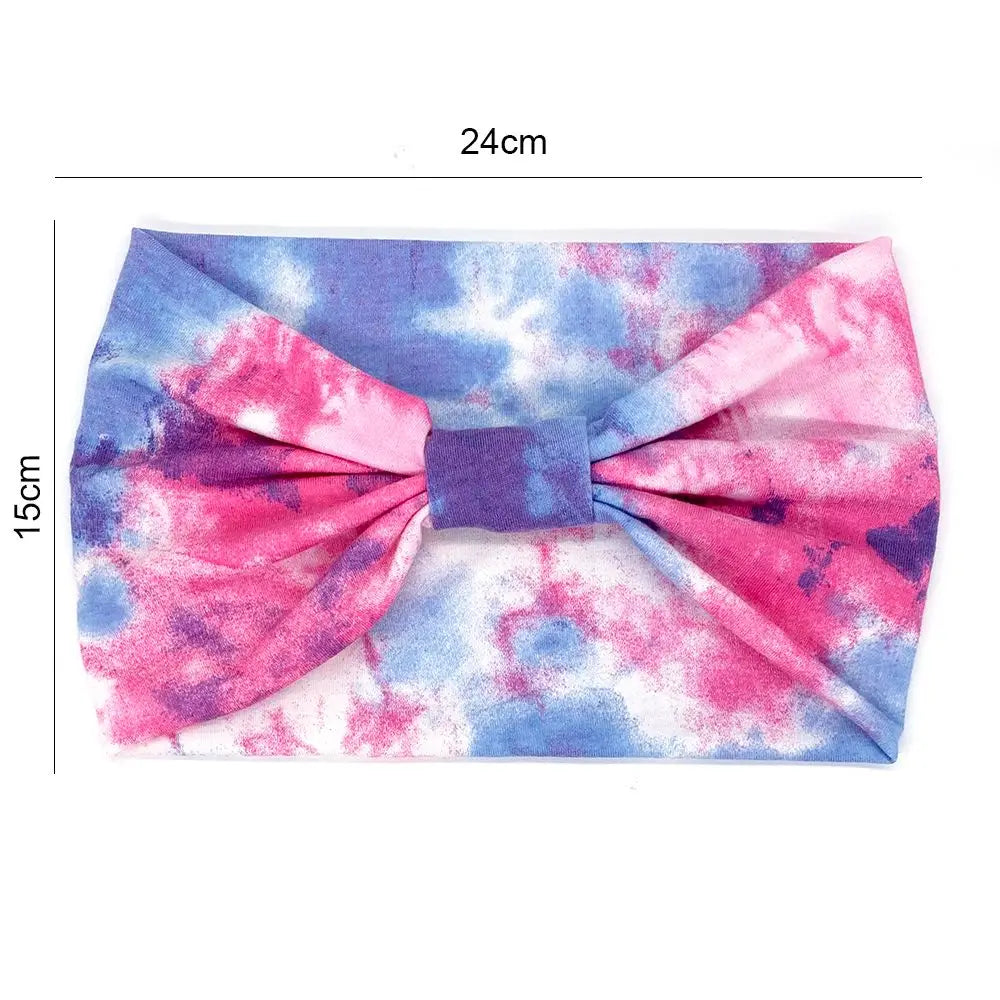 Tie-dye headband with a large bow, shown with measurements on a white background.