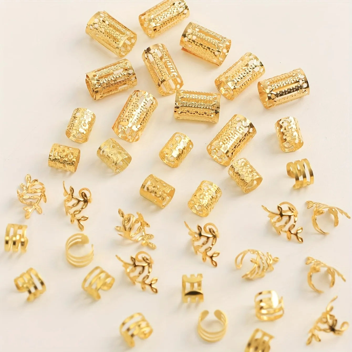 Collection of gold jewelry components on a light background