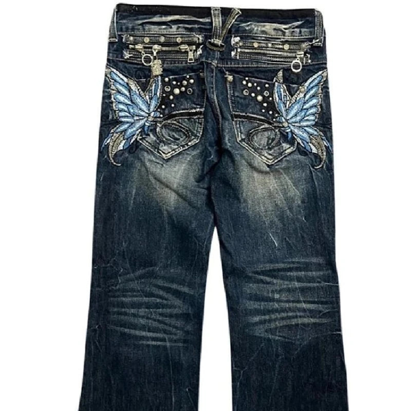 Blue jeans with butterfly designs on the pockets against a white background