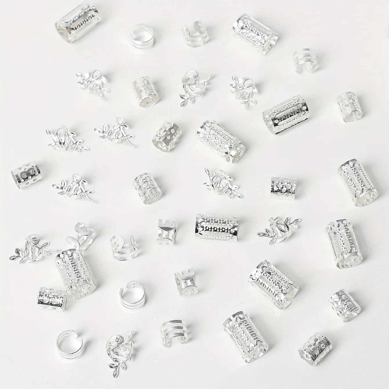 Collection of various silver charms on a white background