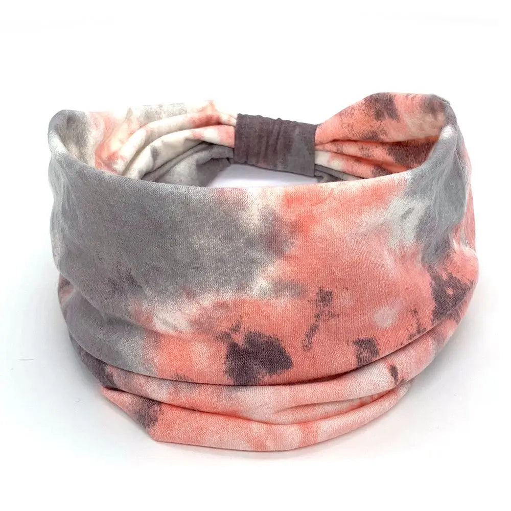 Multicolored headband with pink, gray, and black tie-dye pattern on a white background