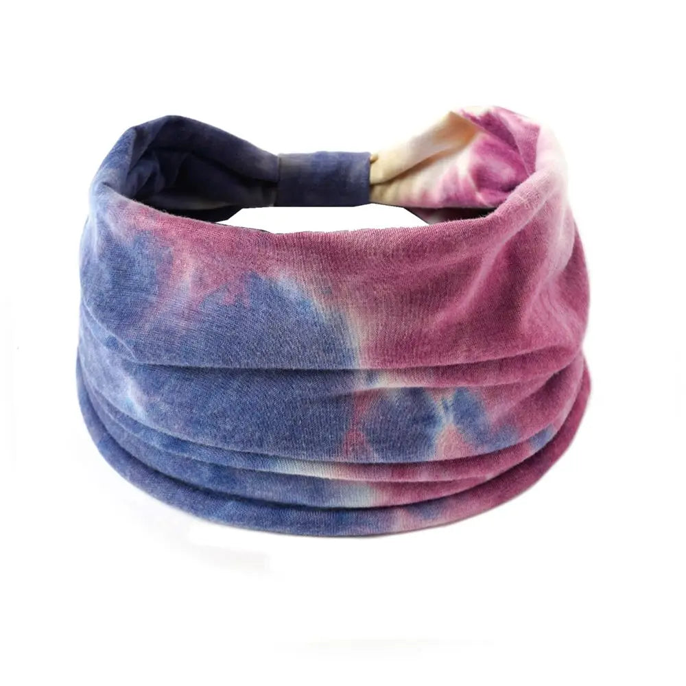 Tie-dye headband with pink and blue gradient on a white background