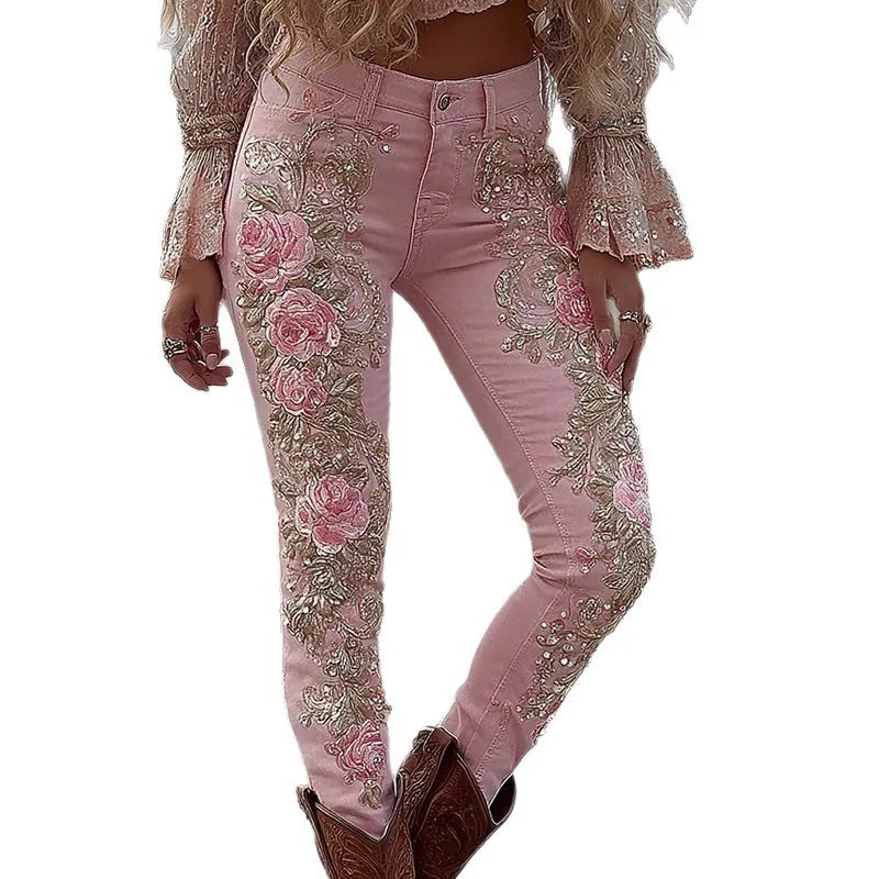 Pink jeans with floral embroidery and embellishments on a white background