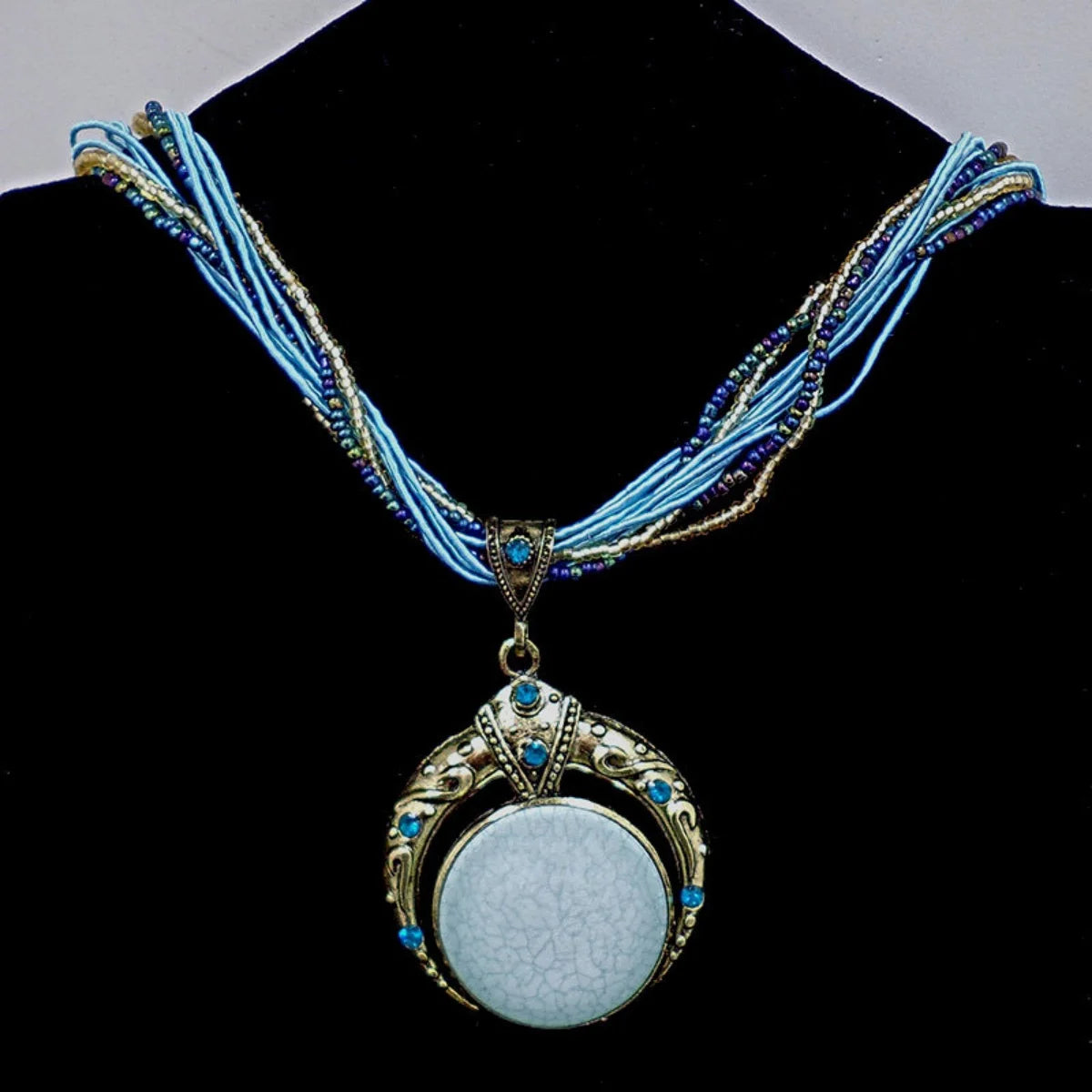 Vintage necklace with a decorative pendant on a black stand