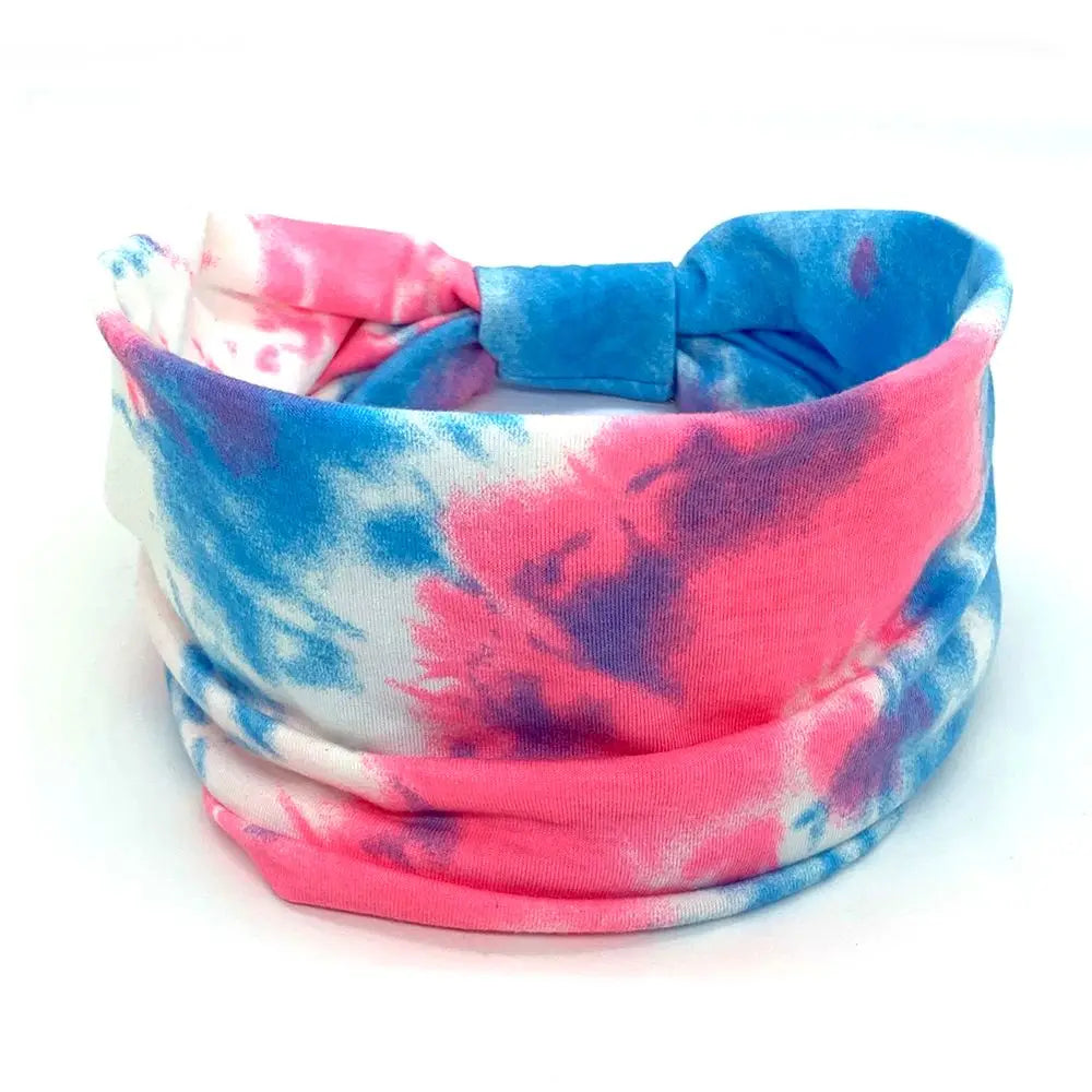 Tie-dye headband with pink and blue patterns on a white background