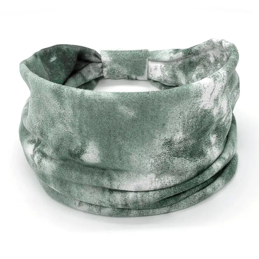 Green and gray patterned headband on a white background