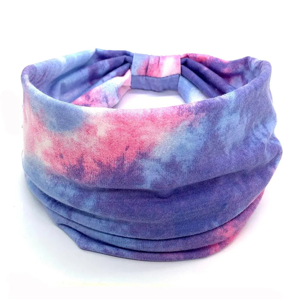 Tie-dye headband with pink and blue gradient on a white background