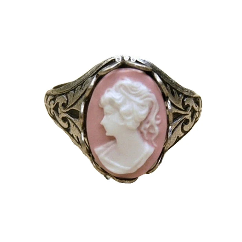 Vintage-style ring with a pink Cameo on a white background