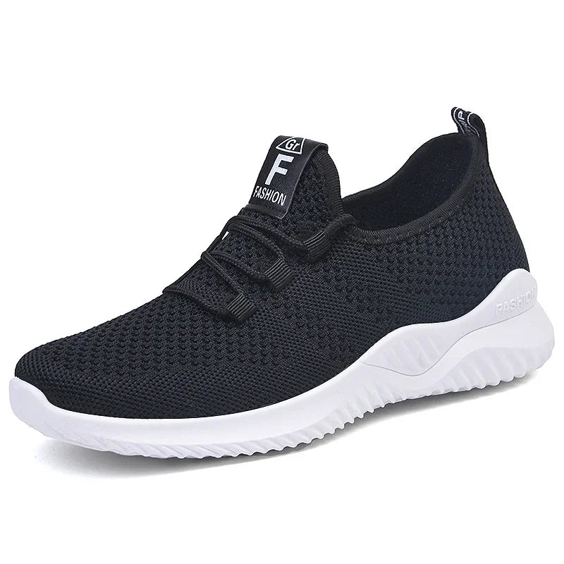 Black slip-on sneaker with white sole on a white background