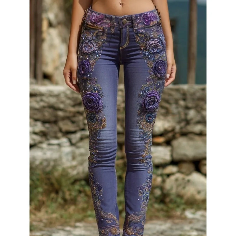Blue jeans with floral embellishments worn by a person against a stone wall background